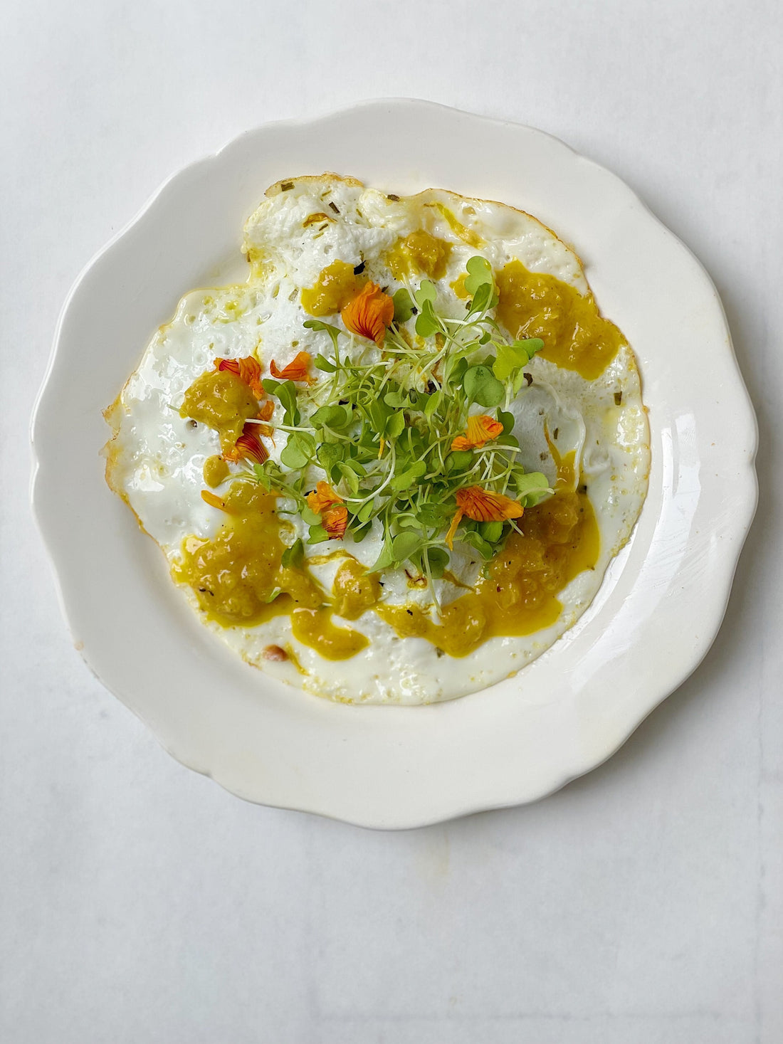 Calendula & Chive Fried Eggs with Golden Pepper Pesto and Greens - Bella Cucina