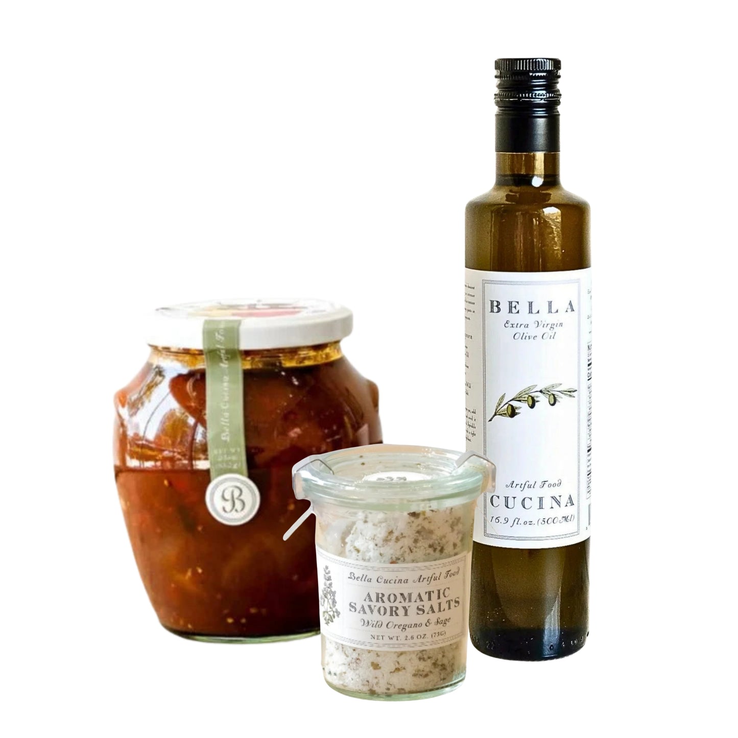 Three gourmet food products from Bella Cucina on a white background: a large glass jar of red chili paste, a small glass jar of aromatic savory salts, and a tall glass bottle of extra virgin olive oil.