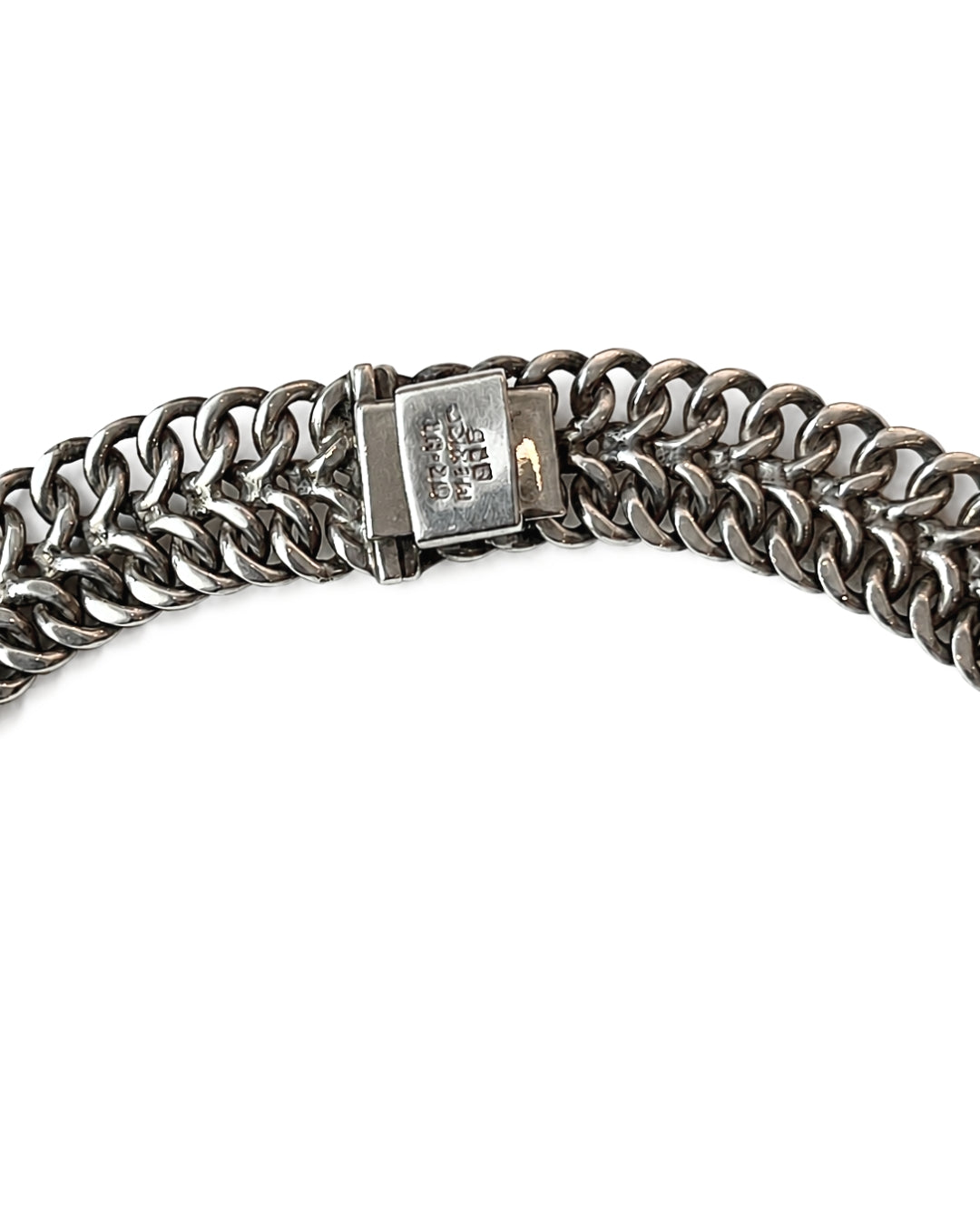 A close-up of a silver-toned metal chain bracelet with a rectangular clasp, photographed on a plain white background.