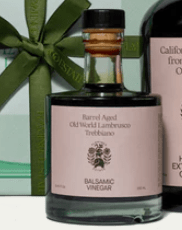 Flamingo Estate Barrel Aged Balsamic Vinegar in elegant gift packaging with green ribbon.