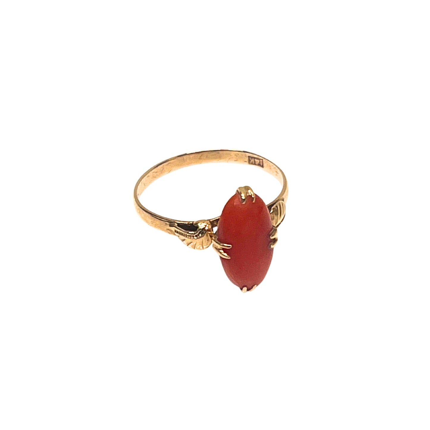 Gold ring with a red stone on a white background