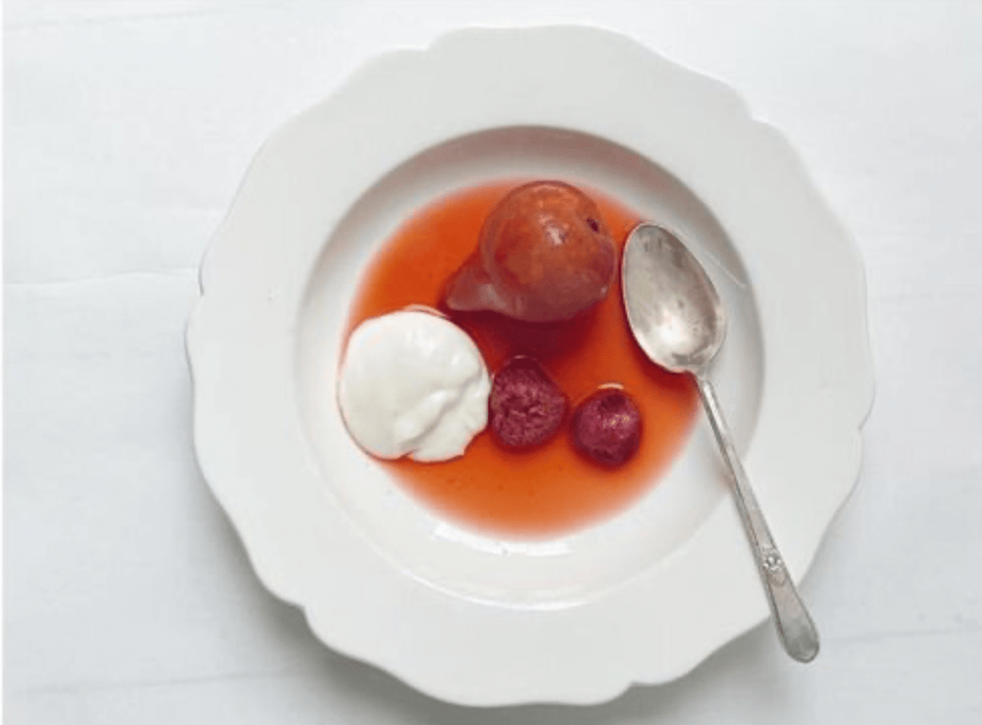 Bella Cucina Poached Pears with Raspberries and Preserved Lemon Cream served in a white bowl