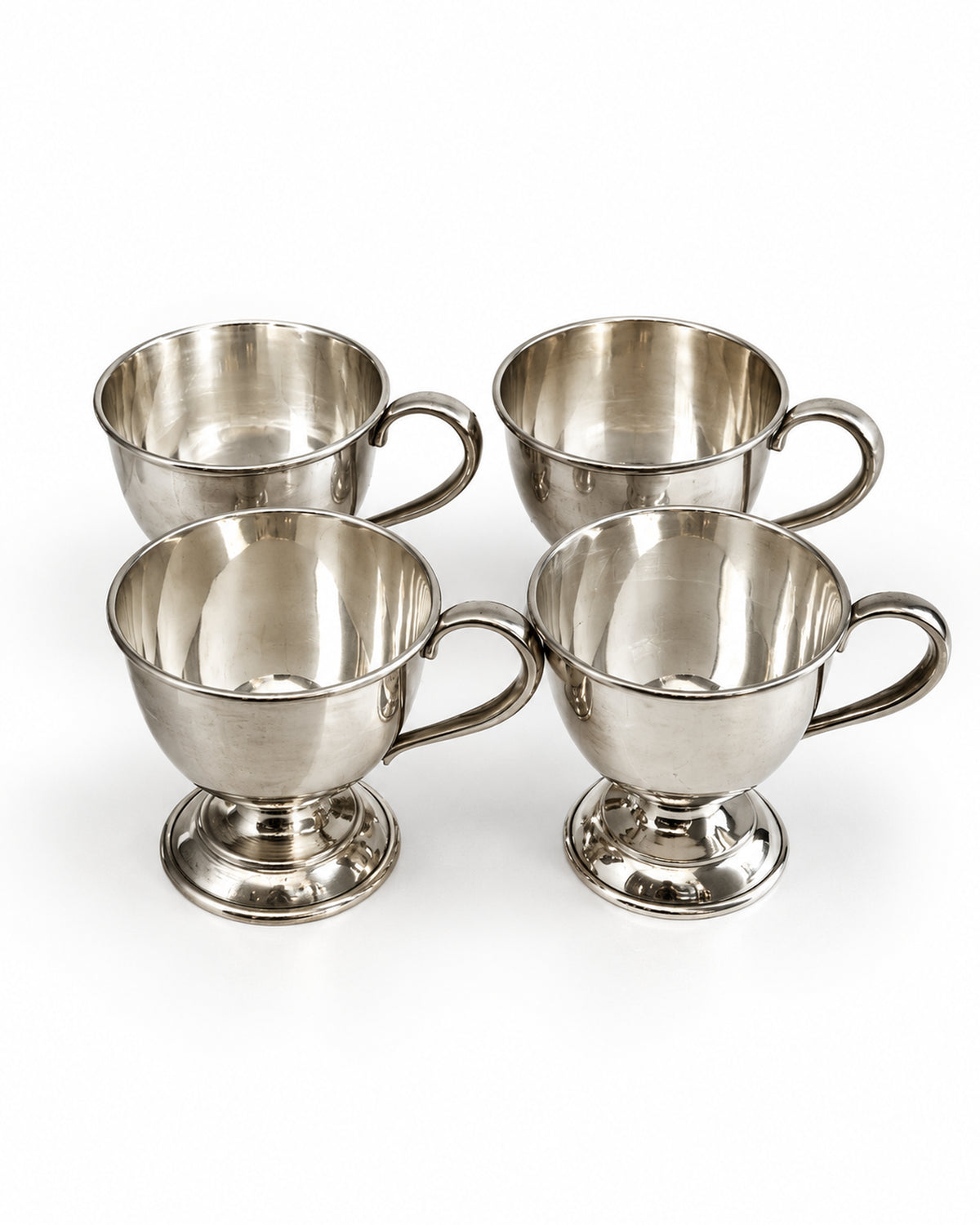 Set of four vintage silver-tone footed cups with loop handles at Bella Cucina in Atlanta