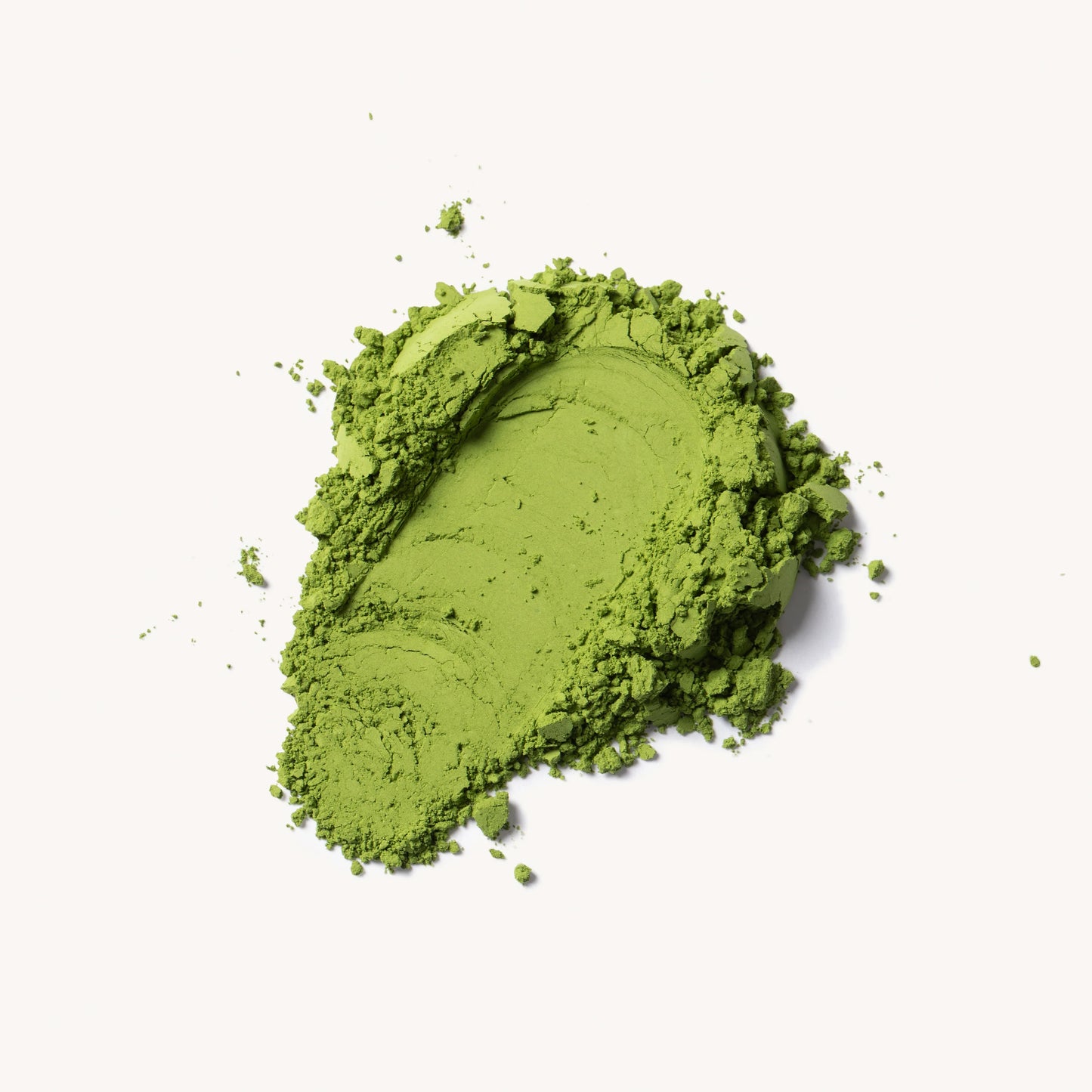 Green powder on a white background
