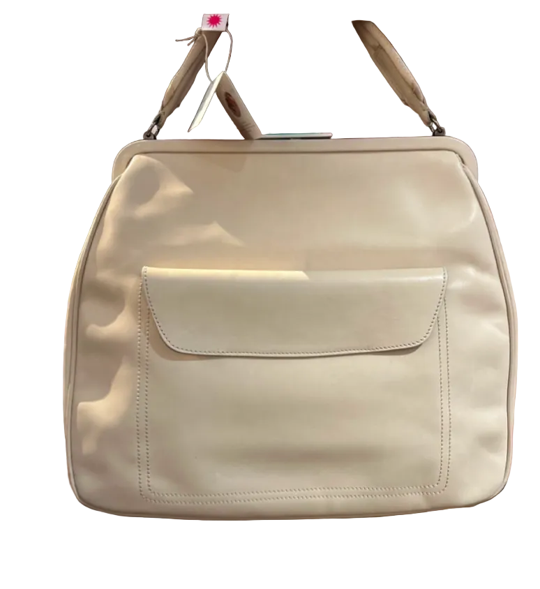 An off-white leather handbag with a front flap pocket, hanging on a wooden display stand.