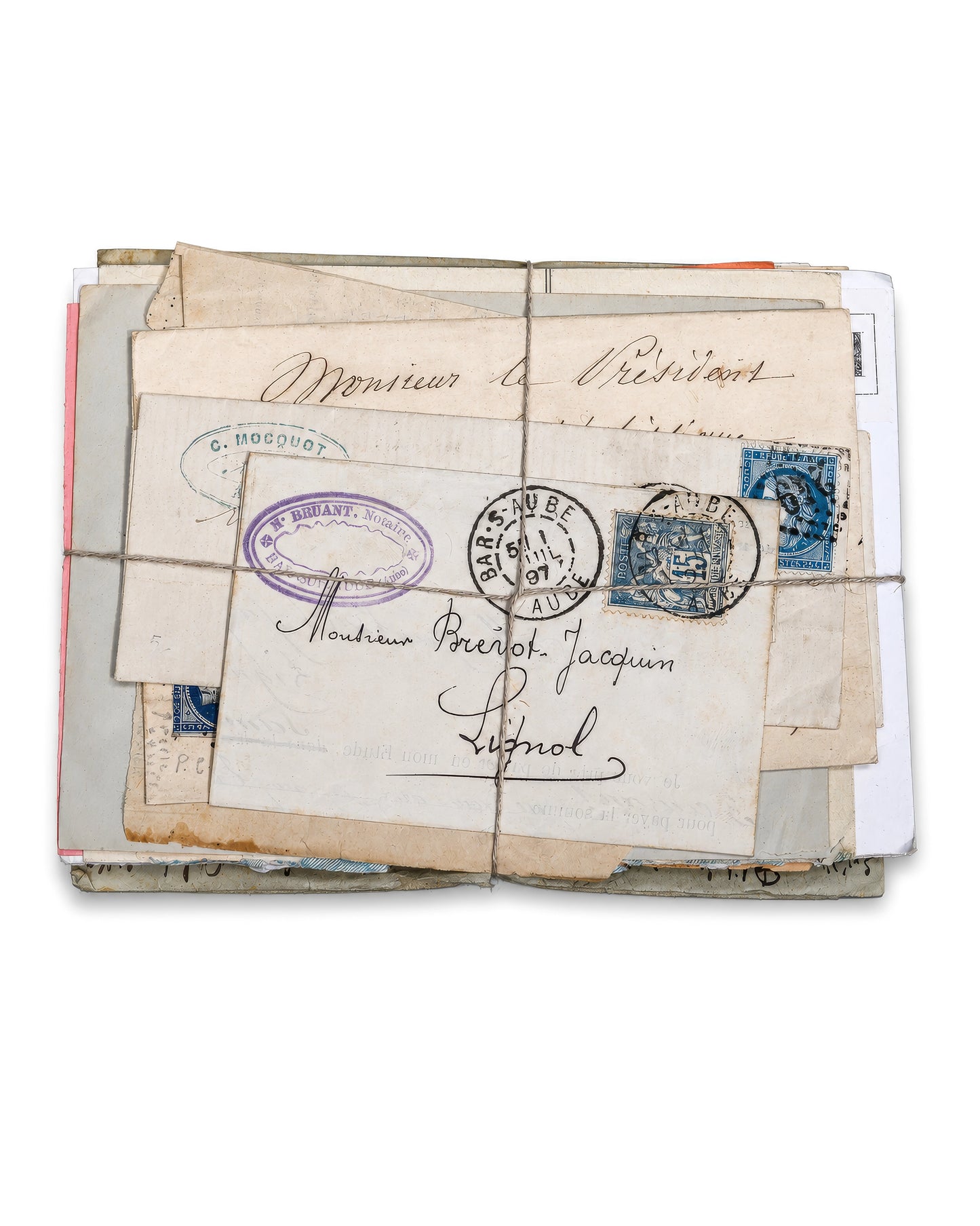 A bundled stack of vintage correspondence tied with string, showing aged cream envelopes, handwritten addresses, blue and purple postage stamps, and circular postmarks. Bundle No. 6 of six one-of-a-kind vintage letter bundles at Bella Cucina.