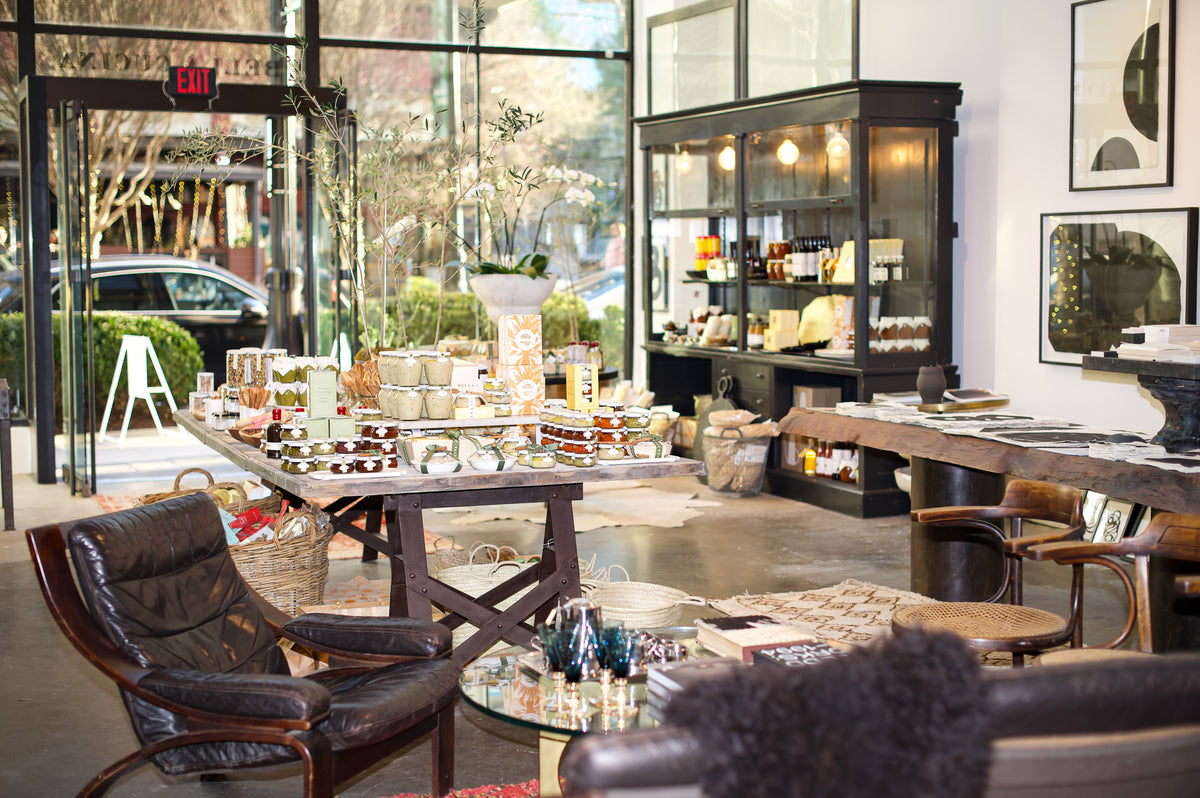 Modern interior with tables, chairs, and decorative items in a stylish setting.