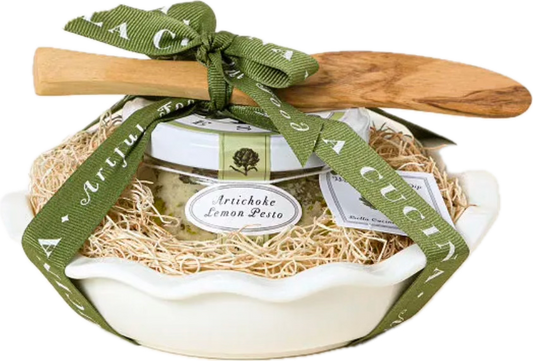 Bella Cucina Artichoke Baking Dish Gift Set with olivewood spreader, porcelain baker, and artichoke lemon pesto tied with green ribbon.