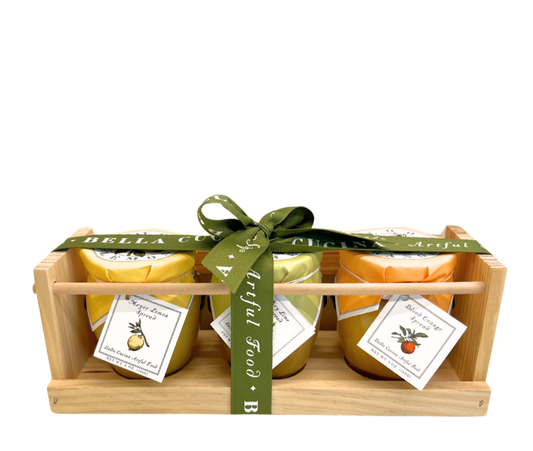 Bella Cucina Citrus Trio Gift Set - a beautifully packaged wooden crate featuring three artisanal citrus spreads: Meyer Lemon, Blood Orange, and Key Lime, wrapped in an elegant ribbon.