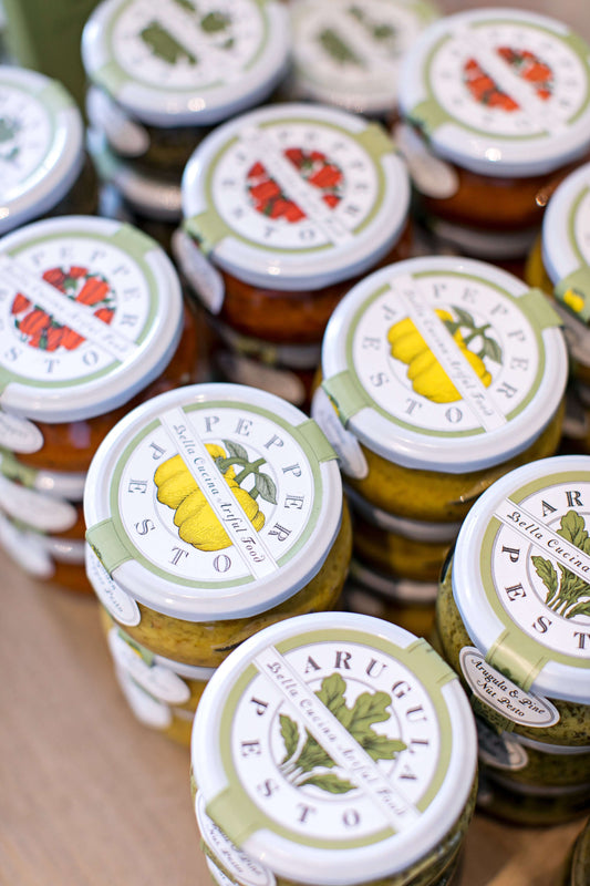 Assorted handcrafted pesto jars by Bella Cucina including arugula and pepper pesto