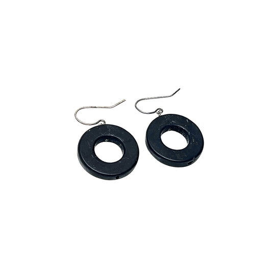 Black circular earrings on a white background