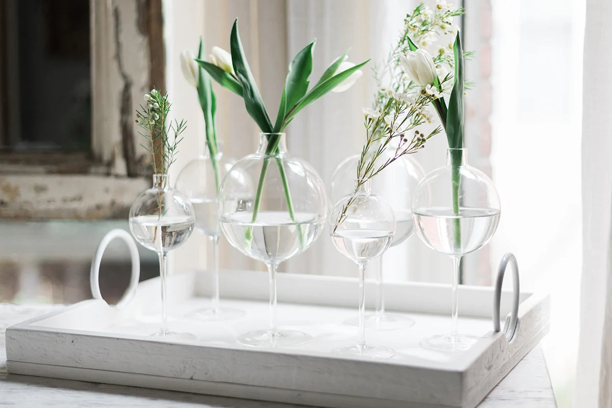 Elegant transparent wine glass vase with a modern spherical design, perfect for home decor and floral arrangements.