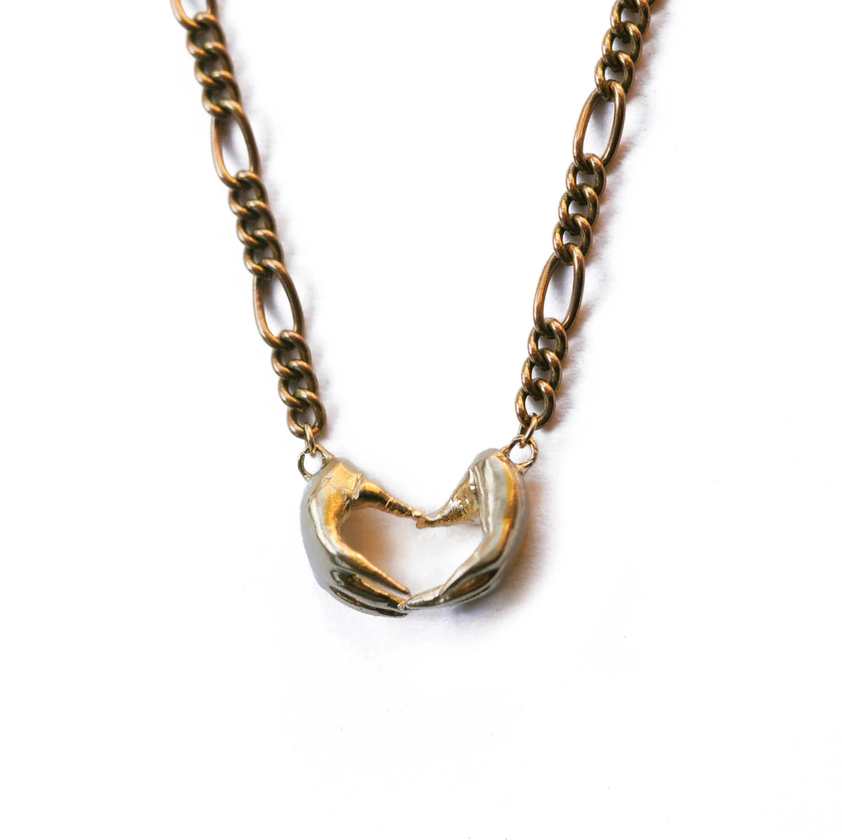 Brass gold interlocking hands necklace at Bella Cucina in Atlanta, view 5