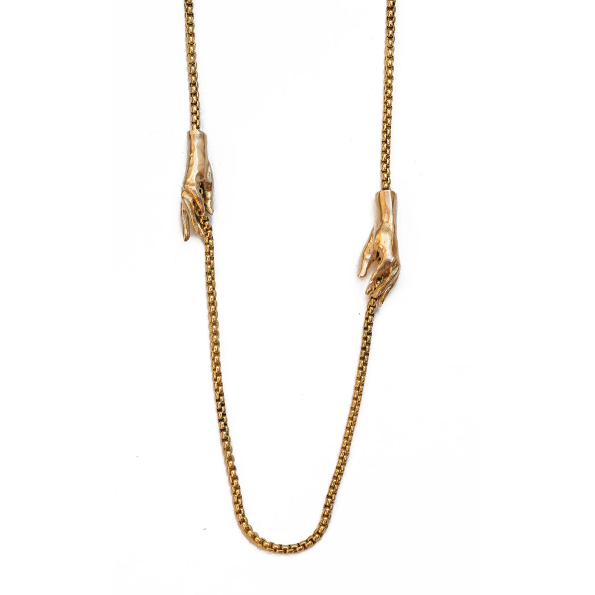 Brass gold interlocking hands necklace at Bella Cucina in Atlanta, view 2