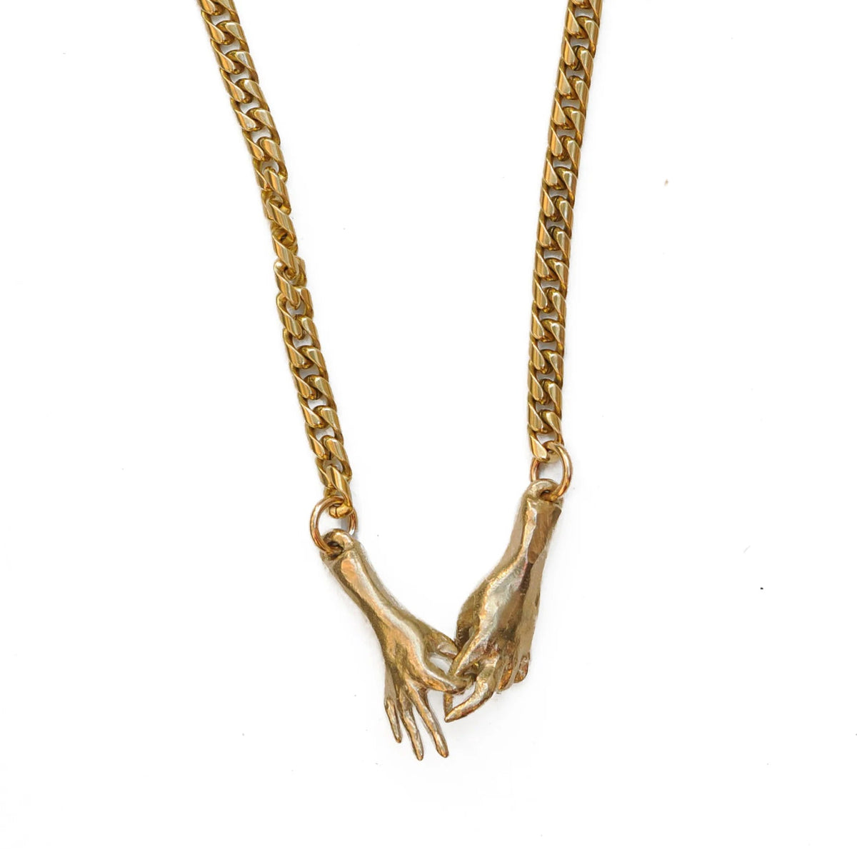 Brass gold interlocking hands necklace at Bella Cucina in Atlanta, view 3