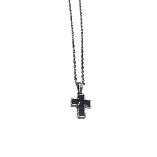 Silver cross necklace with a black stone on a white background