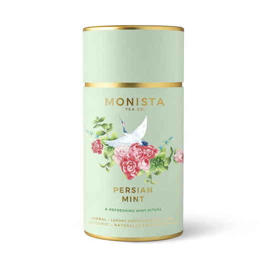 Monista Persian Mint Tea. Refreshing loose leaf organic mint tea with floral accents, beautifully packaged in a soft green and gold tin with a crane and rose design.