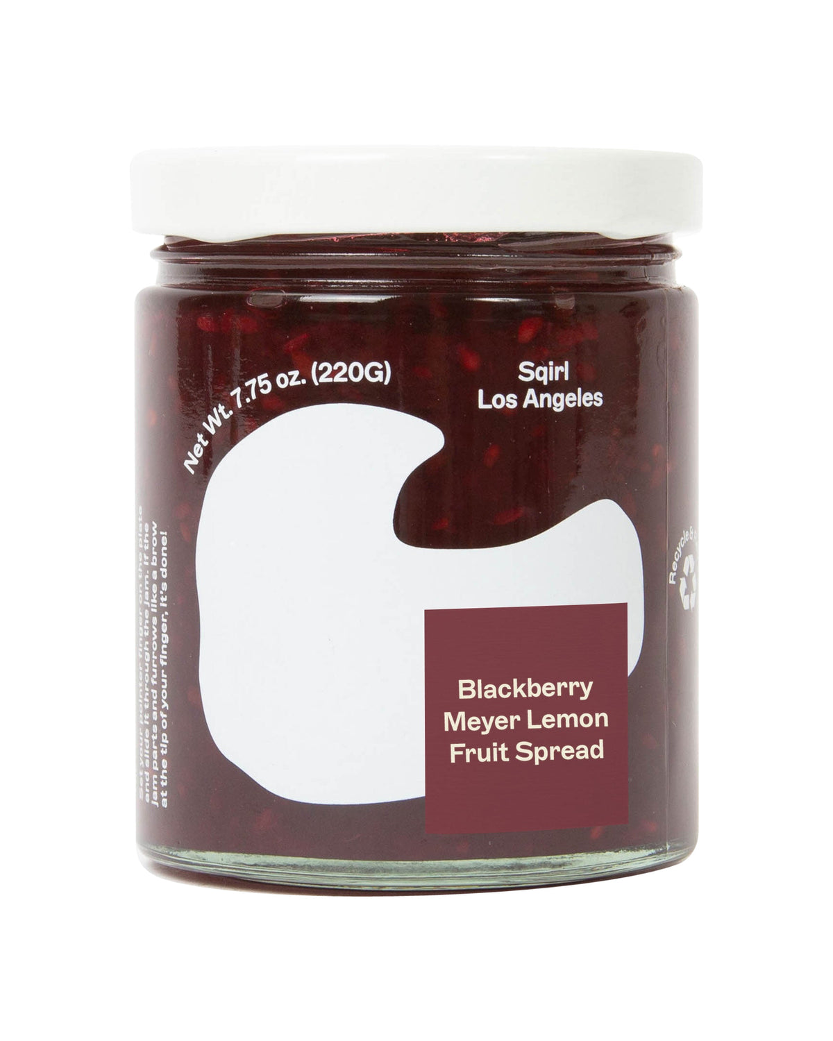 A glass jar of Spirtl Blackberry Meyer Lemon Fruit Spread with a white lid and a white label featuring a large white abstract shape and a dark red square label.