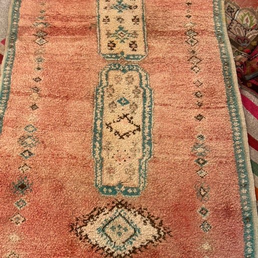 Small vintage Moroccan rug in pink and green at Bella Cucina in Atlanta