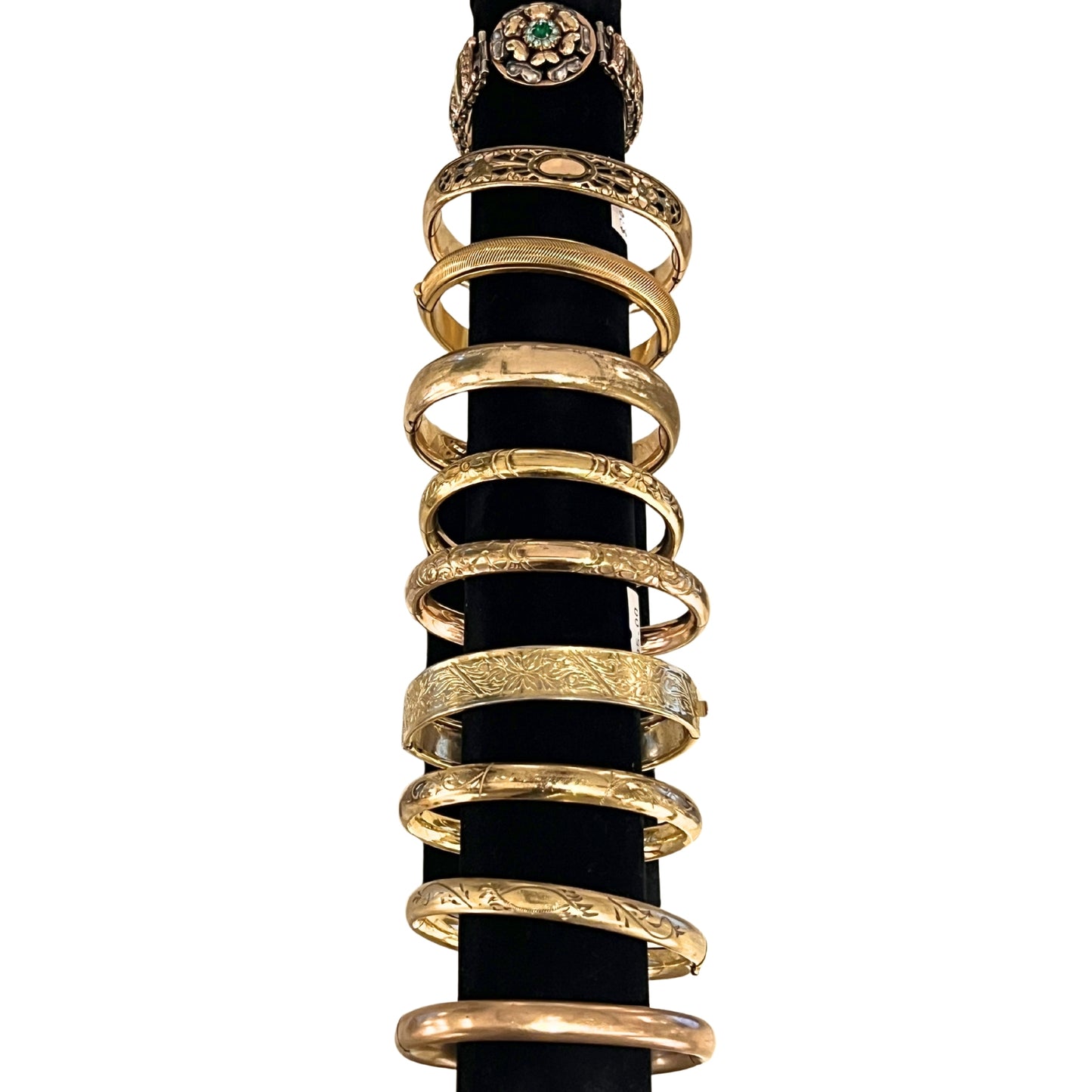 Gold rings stacked on a black background