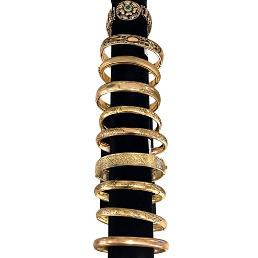 Gold rings stacked on a black background