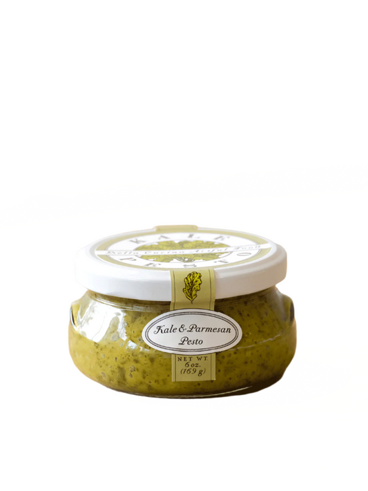 jar of Bella Cucina Kale & Parmesan Pesto, a rich and flavorful artisan pesto made with fresh kale, Parmesan cheese, and olive oil, perfect for pasta, crostini, and dips.