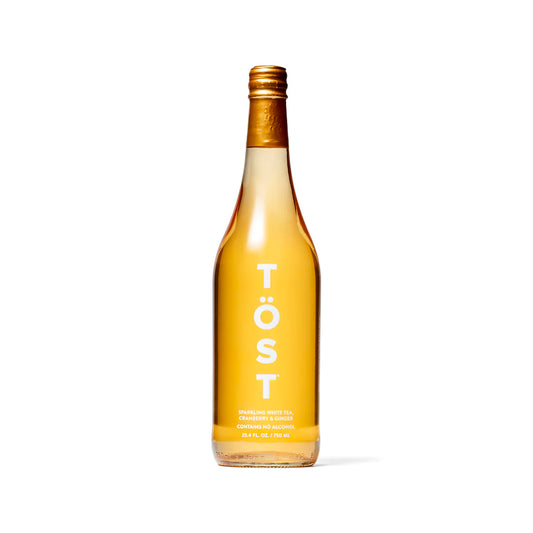 TÖST non-alcoholic sparkling beverage, a crisp and refreshing drink made with white tea, white cranberry, and ginger, available at Bella Cucina.